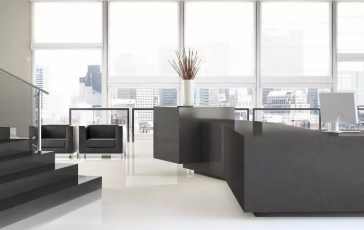 4120 Raven2 a black reception desk in a room with windows