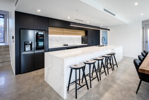a kitchen with a bar and stools