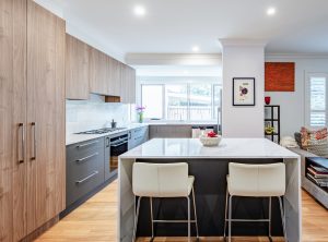 a kitchen with a white countertop and stools