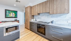 a kitchen with wood cabinets and a stove
