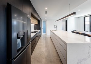a kitchen with a large island and a refrigerator