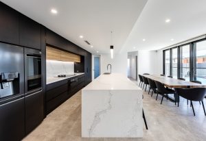 a kitchen with a large island and a dining table