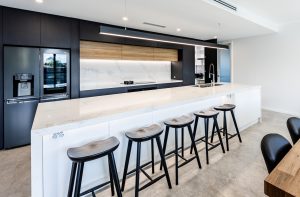 a kitchen with a bar and stools