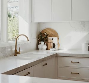 a kitchen with white cabinets and white countertops