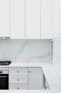 a white kitchen with white cabinets and white counter tops