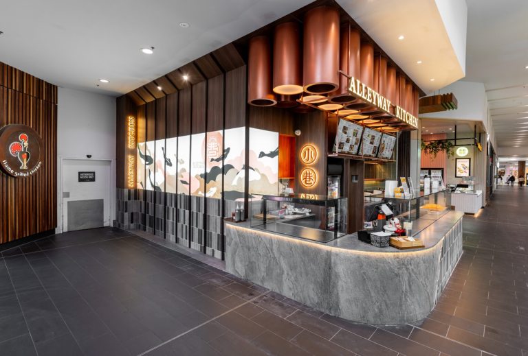 a restaurant with a counter and a sign