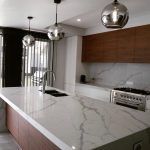 a kitchen with marble countertop and stainless steel appliances