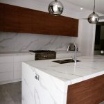 a kitchen with marble counter tops and stainless steel appliances