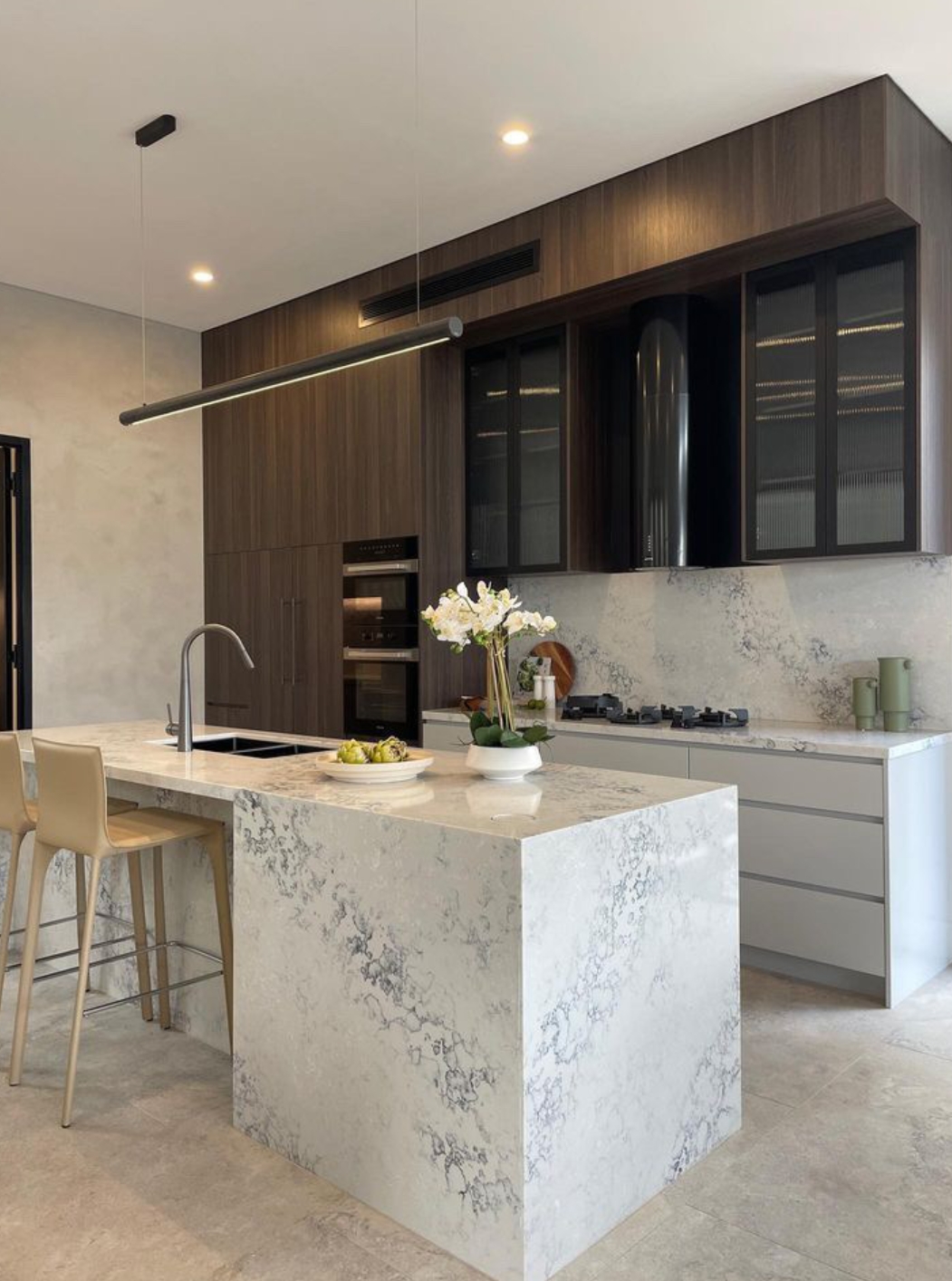 Snowy Mountain (AC8000)5 a kitchen with a marble island and stools