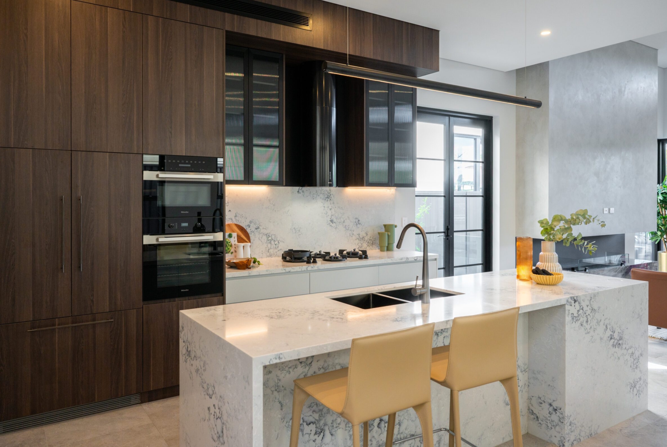 Snowy Mountain (AC8000)6 a kitchen with a marble island and chairs