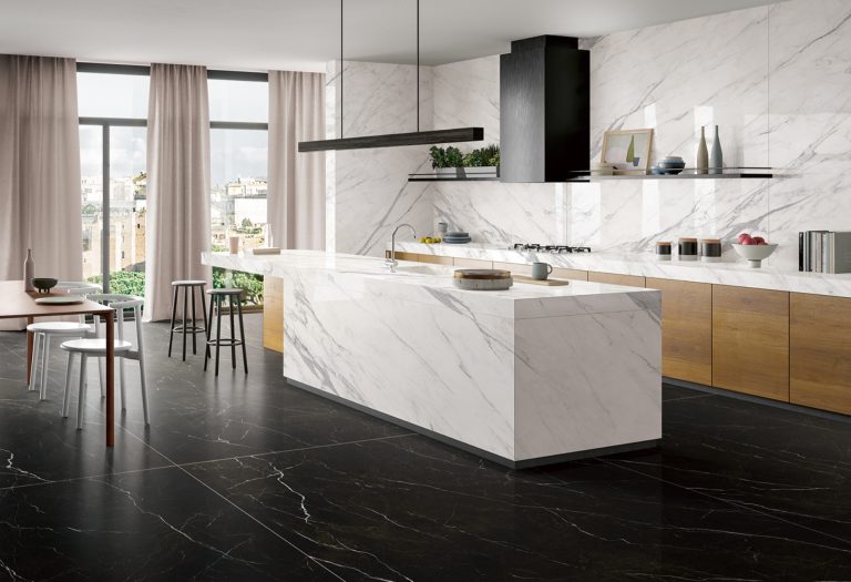 a kitchen with marble island and chairs