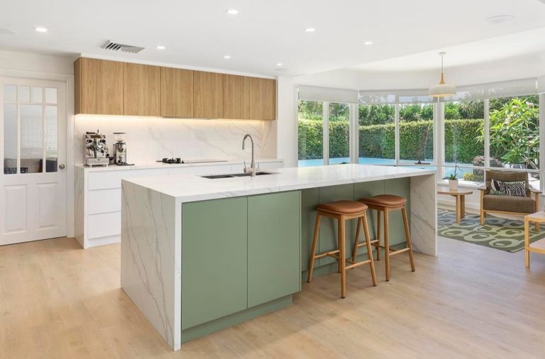 a kitchen with a bar and stools