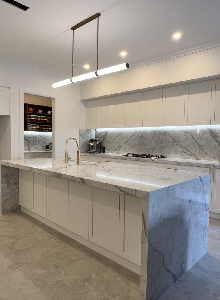 a kitchen with marble island