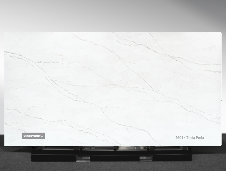 Vicostone Theia Perla 1601 quartz slab soft white surface with warm flowing veins close-up