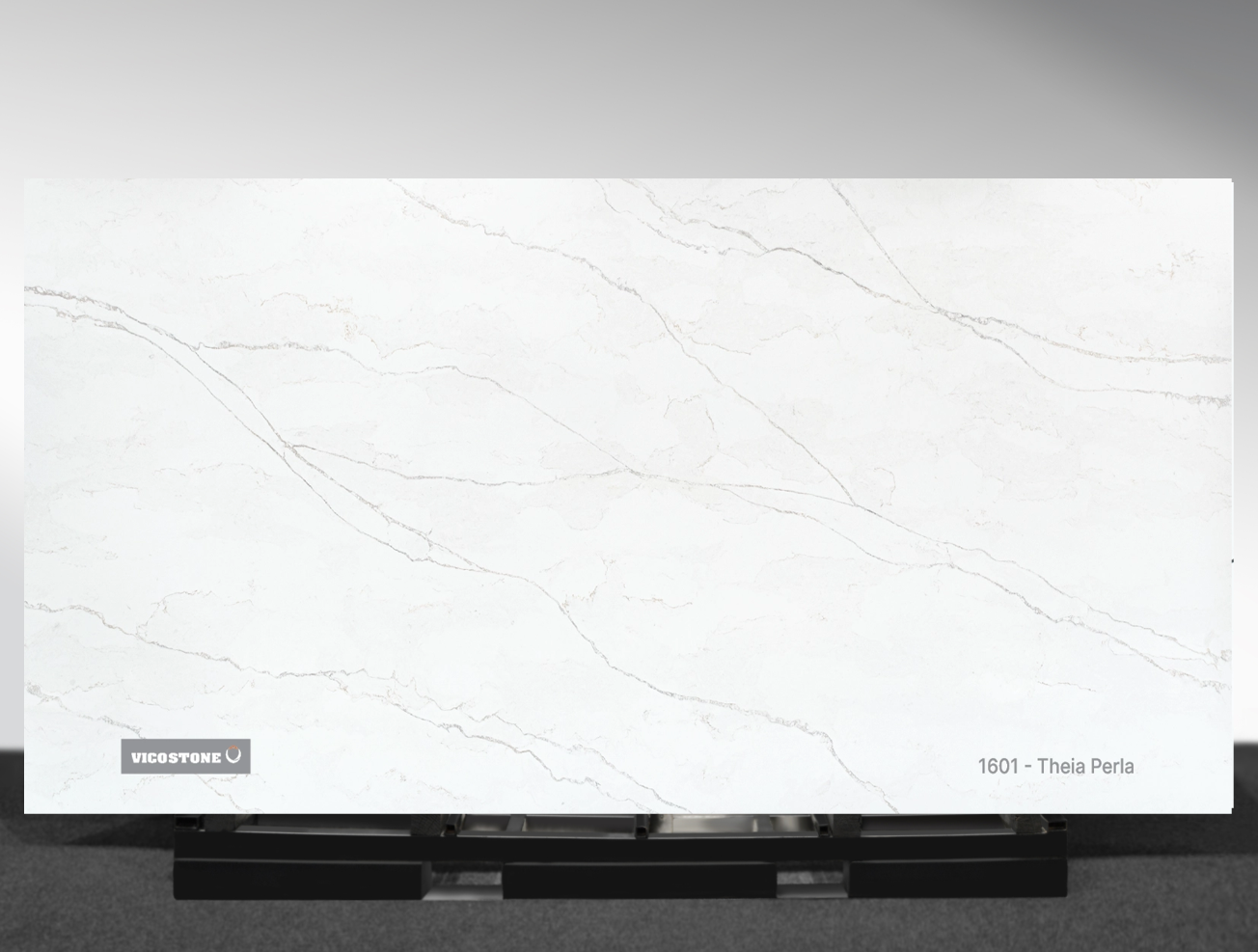 1601 Theia Perla Vicostone Theia Perla 1601 quartz slab soft white surface with warm flowing veins close-up