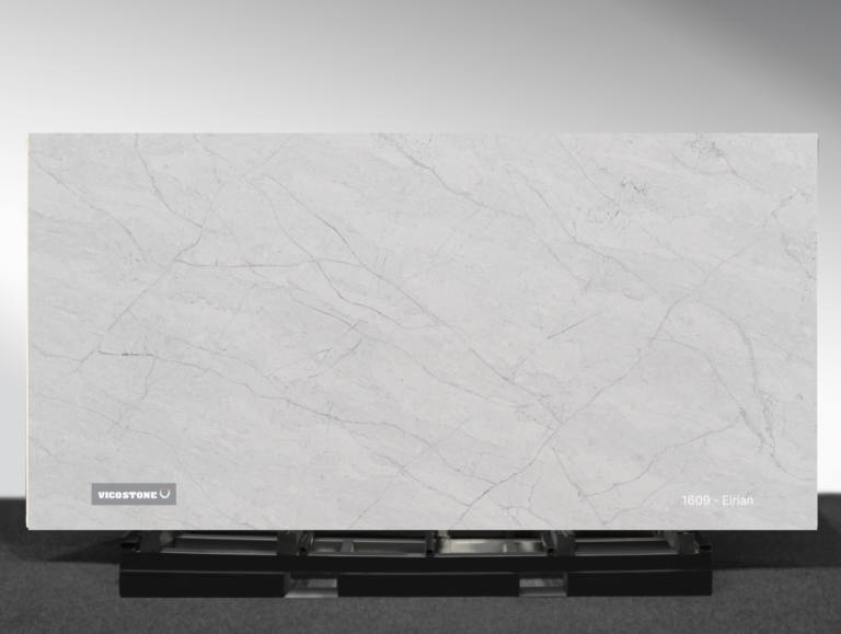Vicostone Eirian 1609 quartz slab warm gray surface with bold flowing veins close-up