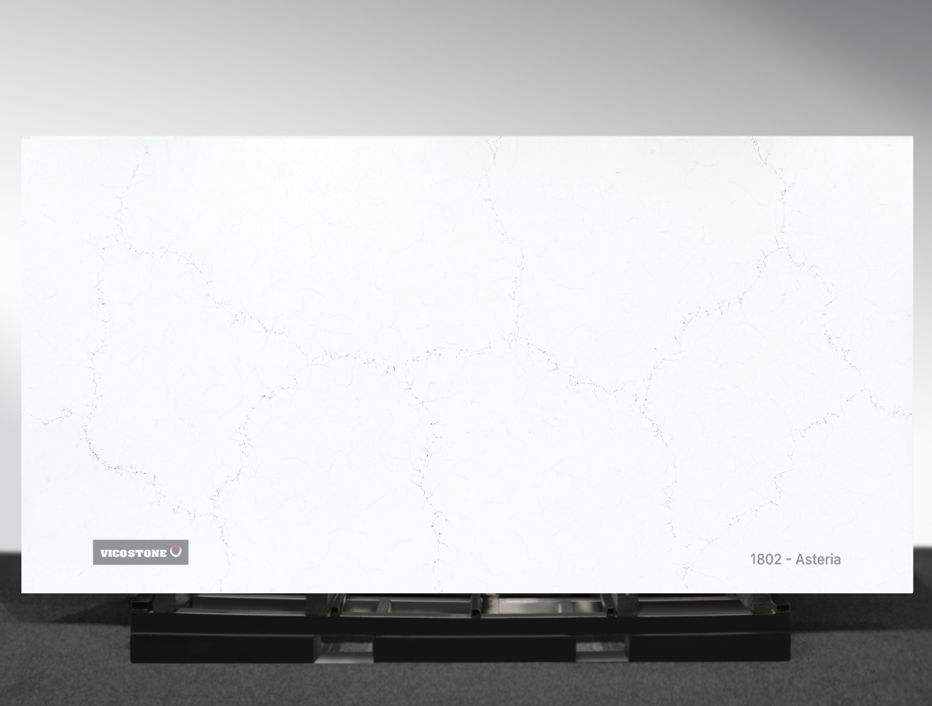 1802 Asteria Vicostone Asteria 1802 quartz slab white surface with delicate flowing veins close-up